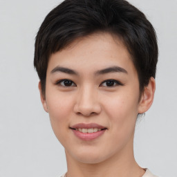 Joyful asian young-adult female with short  brown hair and brown eyes