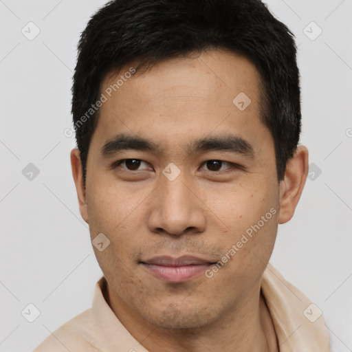 Joyful latino young-adult male with short  black hair and brown eyes