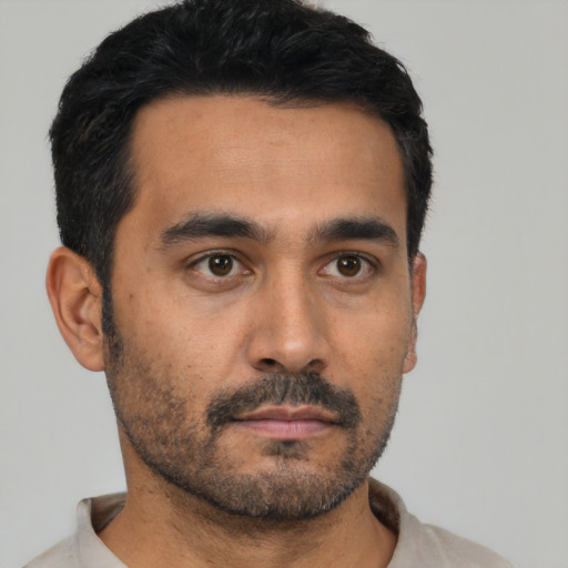 Neutral latino young-adult male with short  black hair and brown eyes