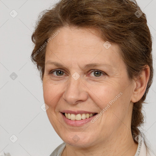 Joyful white adult female with short  brown hair and brown eyes