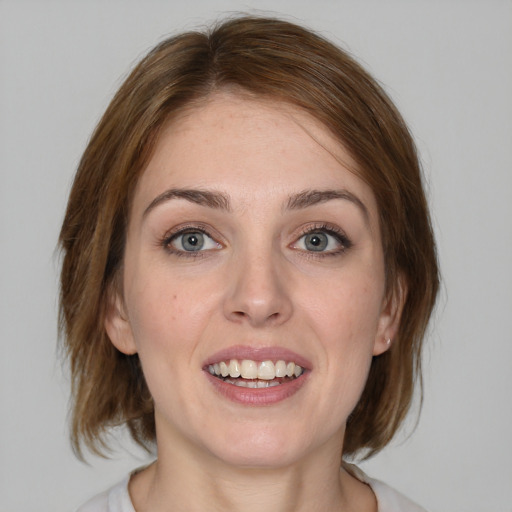 Joyful white young-adult female with medium  brown hair and blue eyes