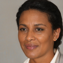 Joyful black adult female with medium  brown hair and brown eyes