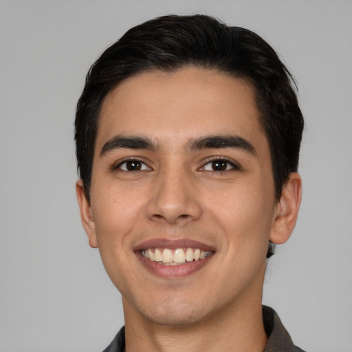 Joyful white young-adult male with short  black hair and brown eyes