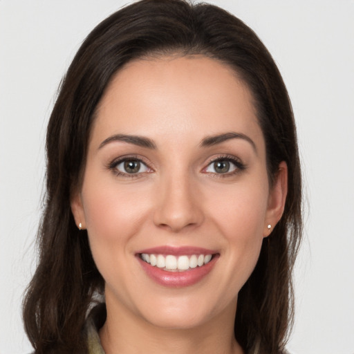 Joyful white young-adult female with long  brown hair and brown eyes