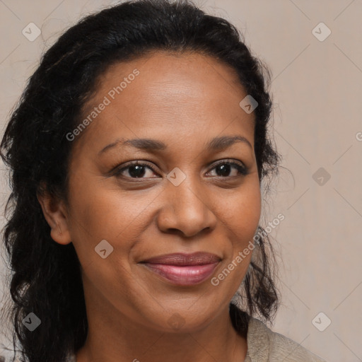 Joyful black adult female with long  brown hair and brown eyes