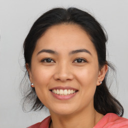 Joyful latino young-adult female with medium  brown hair and brown eyes