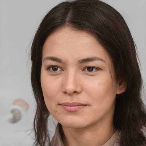 Joyful white young-adult female with long  brown hair and brown eyes