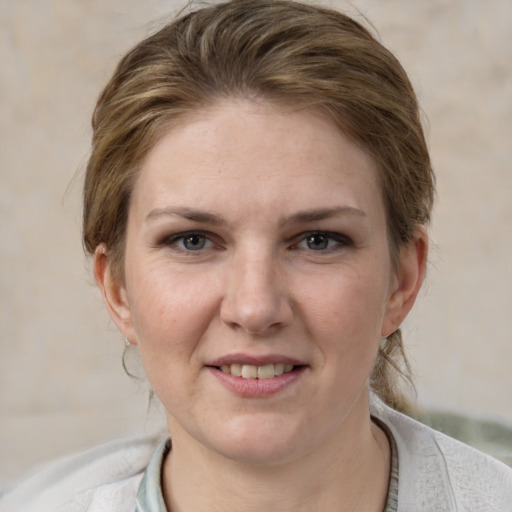 Joyful white adult female with medium  brown hair and grey eyes