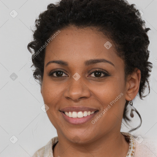 Joyful black young-adult female with long  brown hair and brown eyes