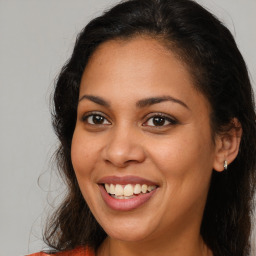 Joyful latino young-adult female with long  brown hair and brown eyes