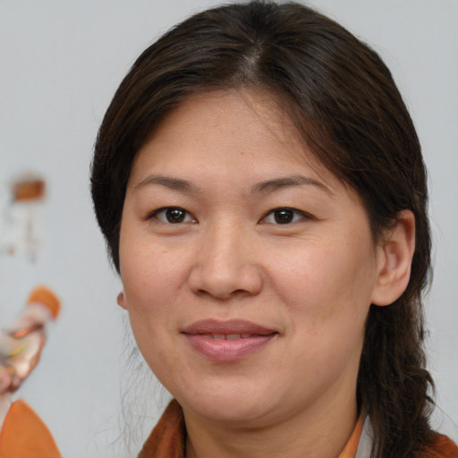 Joyful white adult female with medium  brown hair and brown eyes