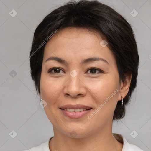 Joyful asian adult female with medium  brown hair and brown eyes