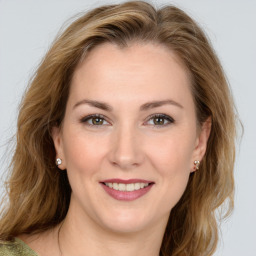 Joyful white young-adult female with medium  brown hair and green eyes