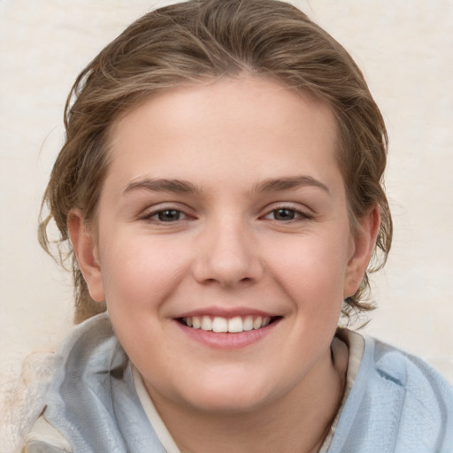 Joyful white child female with medium  brown hair and brown eyes