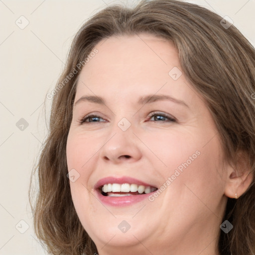 Joyful white young-adult female with long  brown hair and green eyes