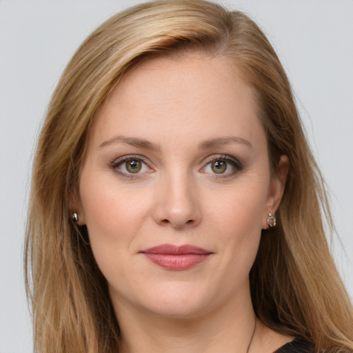 Joyful white young-adult female with long  brown hair and green eyes