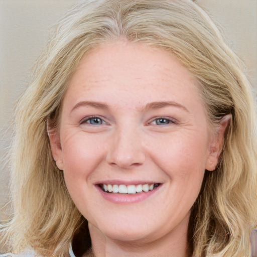 Joyful white young-adult female with long  brown hair and blue eyes