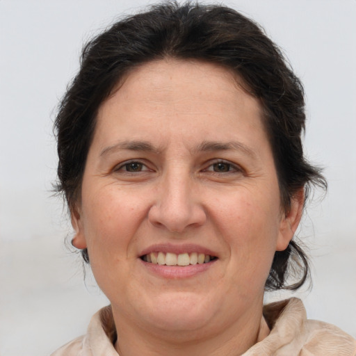 Joyful white adult female with medium  brown hair and brown eyes