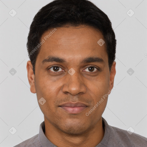 Joyful black young-adult male with short  black hair and brown eyes