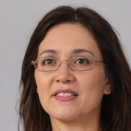 Joyful white adult female with long  brown hair and brown eyes