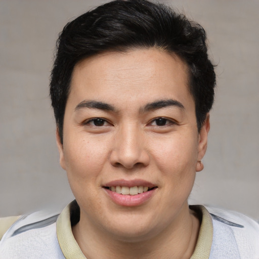 Joyful asian young-adult male with short  brown hair and brown eyes