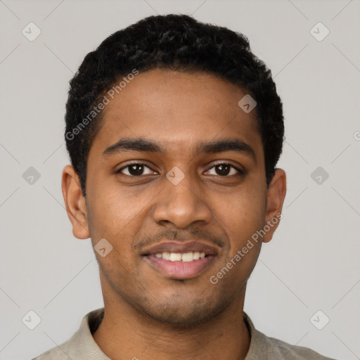 Joyful black young-adult male with short  black hair and brown eyes