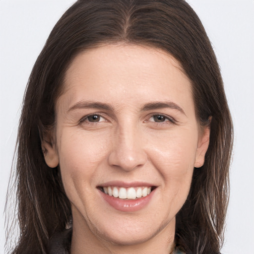 Joyful white young-adult female with long  brown hair and brown eyes