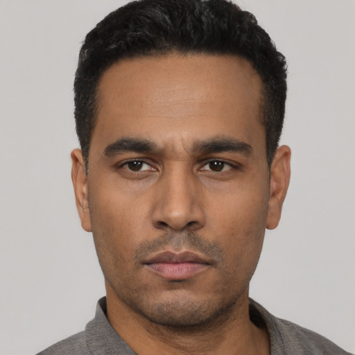 Neutral latino young-adult male with short  black hair and brown eyes