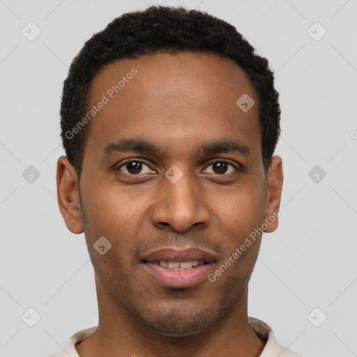 Joyful black young-adult male with short  brown hair and brown eyes