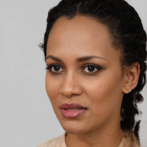 Joyful black young-adult female with short  black hair and brown eyes