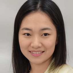 Joyful asian young-adult female with long  brown hair and brown eyes