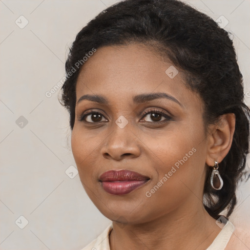 Joyful black young-adult female with long  brown hair and brown eyes