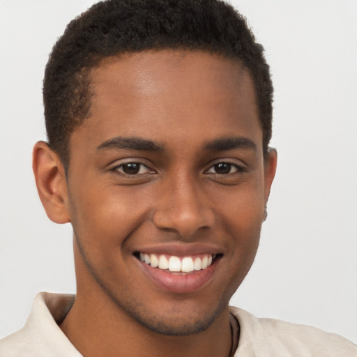 Joyful black young-adult male with short  brown hair and brown eyes