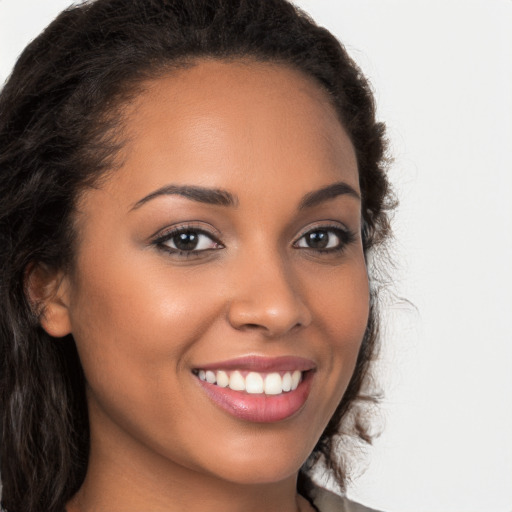 Joyful latino young-adult female with long  brown hair and brown eyes