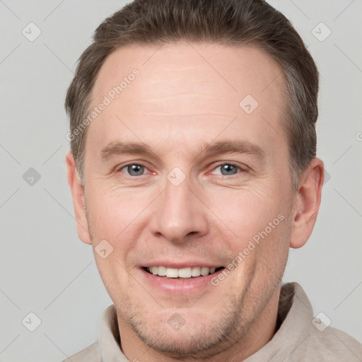 Joyful white adult male with short  brown hair and grey eyes