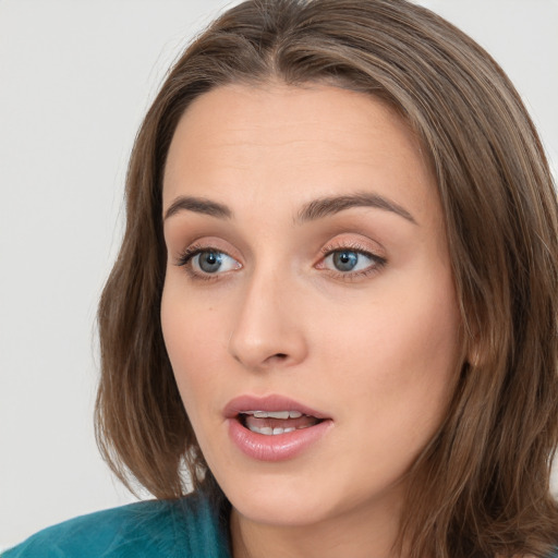 Neutral white young-adult female with long  brown hair and blue eyes