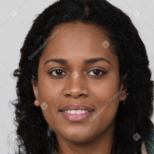 Joyful black young-adult female with long  brown hair and brown eyes