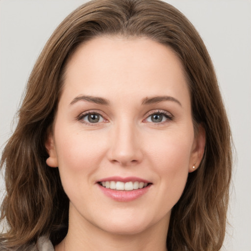 Joyful white young-adult female with long  brown hair and green eyes