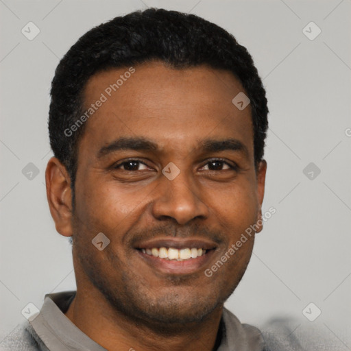Joyful latino young-adult male with short  black hair and brown eyes