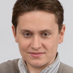 Joyful white adult male with short  brown hair and grey eyes