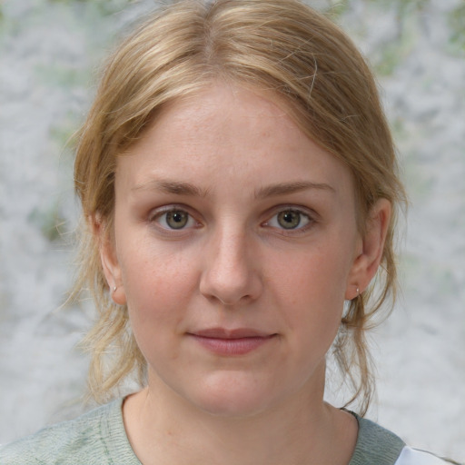 Joyful white young-adult female with medium  brown hair and blue eyes