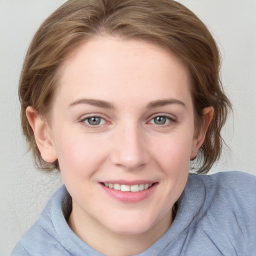 Joyful white young-adult female with medium  brown hair and blue eyes