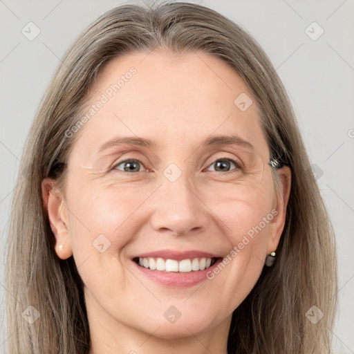 Joyful white adult female with long  brown hair and grey eyes