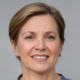 Joyful white adult female with medium  brown hair and grey eyes