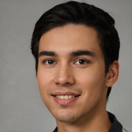 Joyful white young-adult male with short  black hair and brown eyes