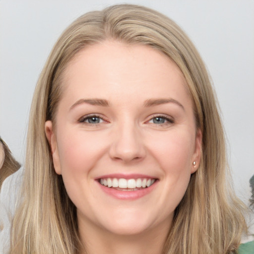 Joyful white young-adult female with long  brown hair and grey eyes