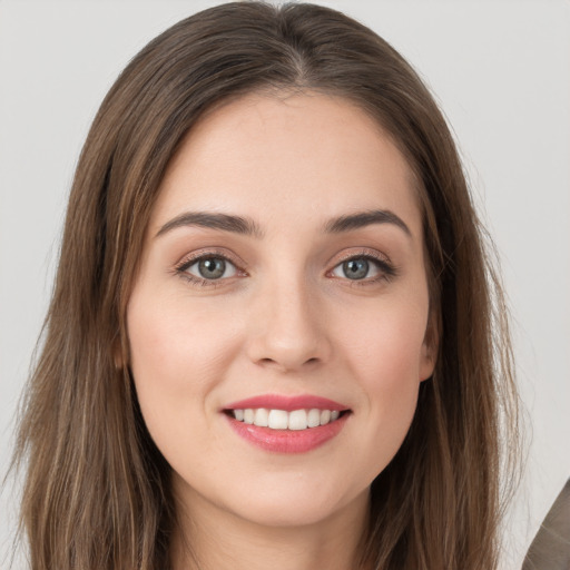 Joyful white young-adult female with long  brown hair and grey eyes