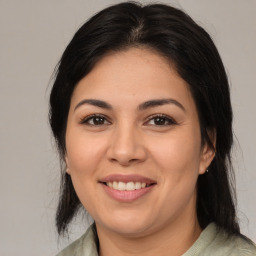 Joyful latino adult female with medium  brown hair and brown eyes