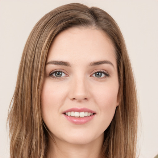 Joyful white young-adult female with long  brown hair and green eyes