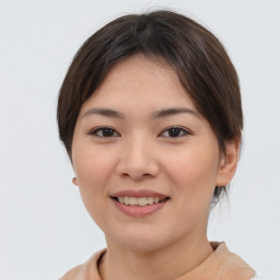 Joyful asian young-adult female with short  brown hair and brown eyes